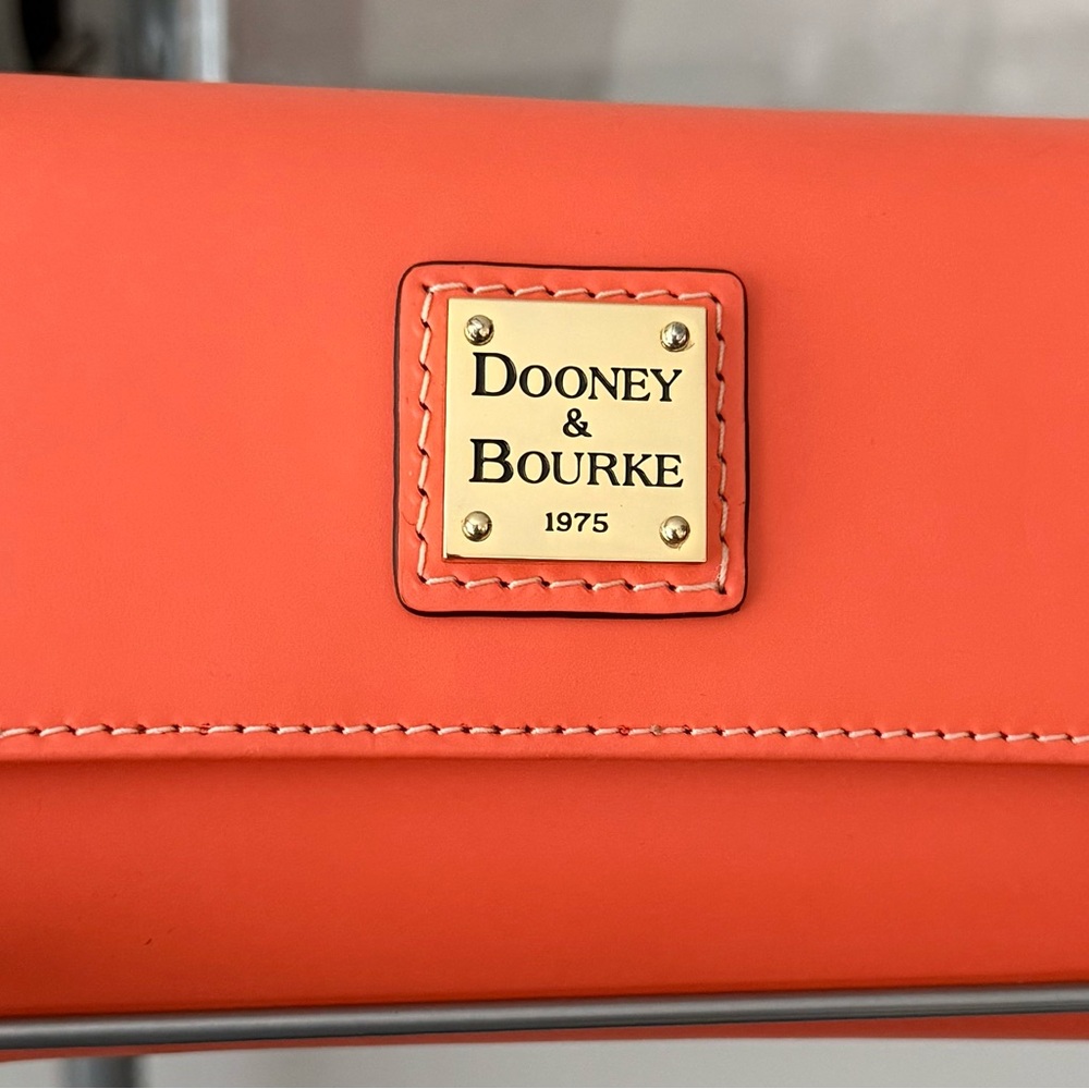 Dooney & Bourke small flap coral wallet, new.